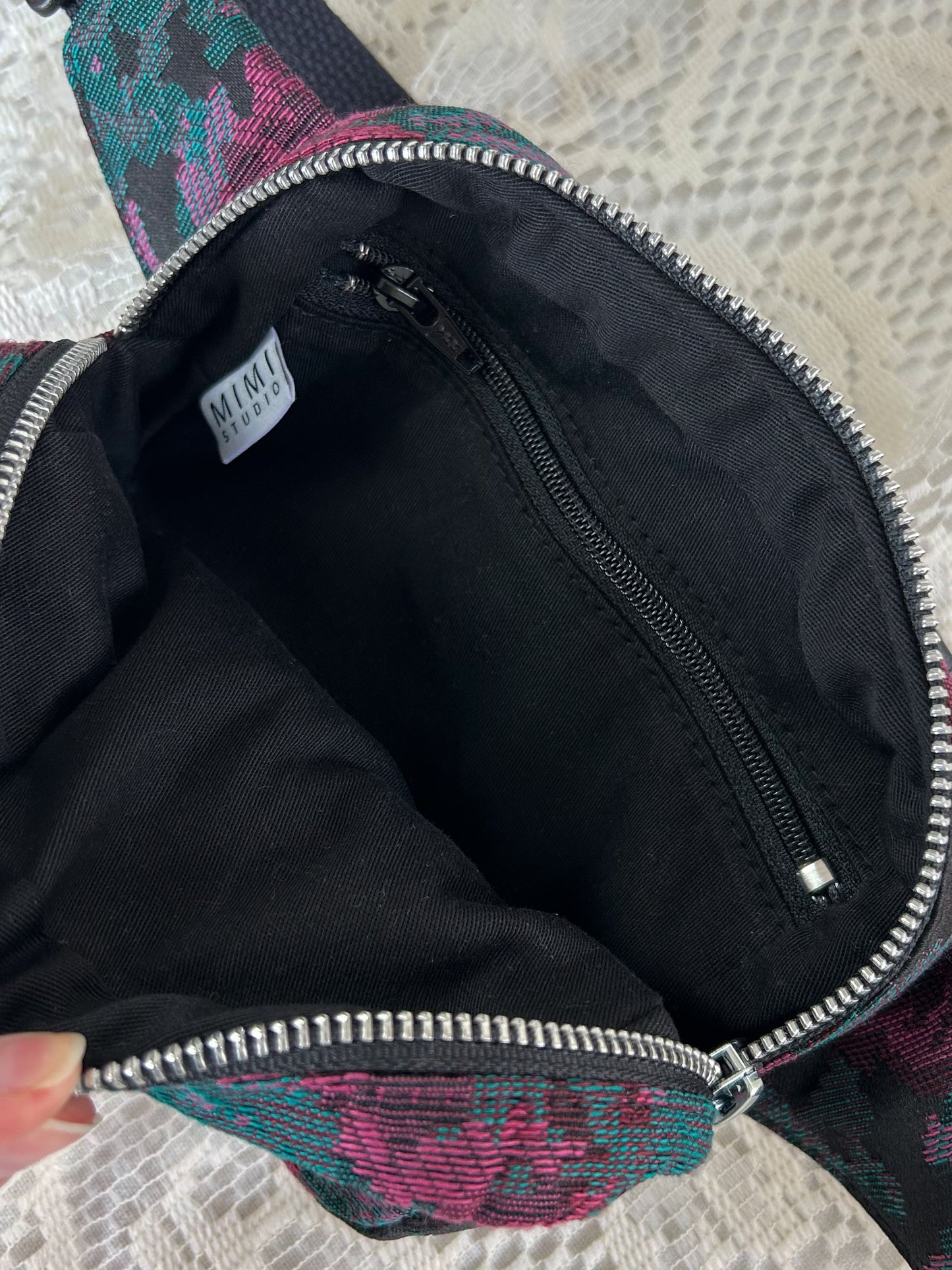 Black twill interior lining of the same fanny pack with a zippered pocket