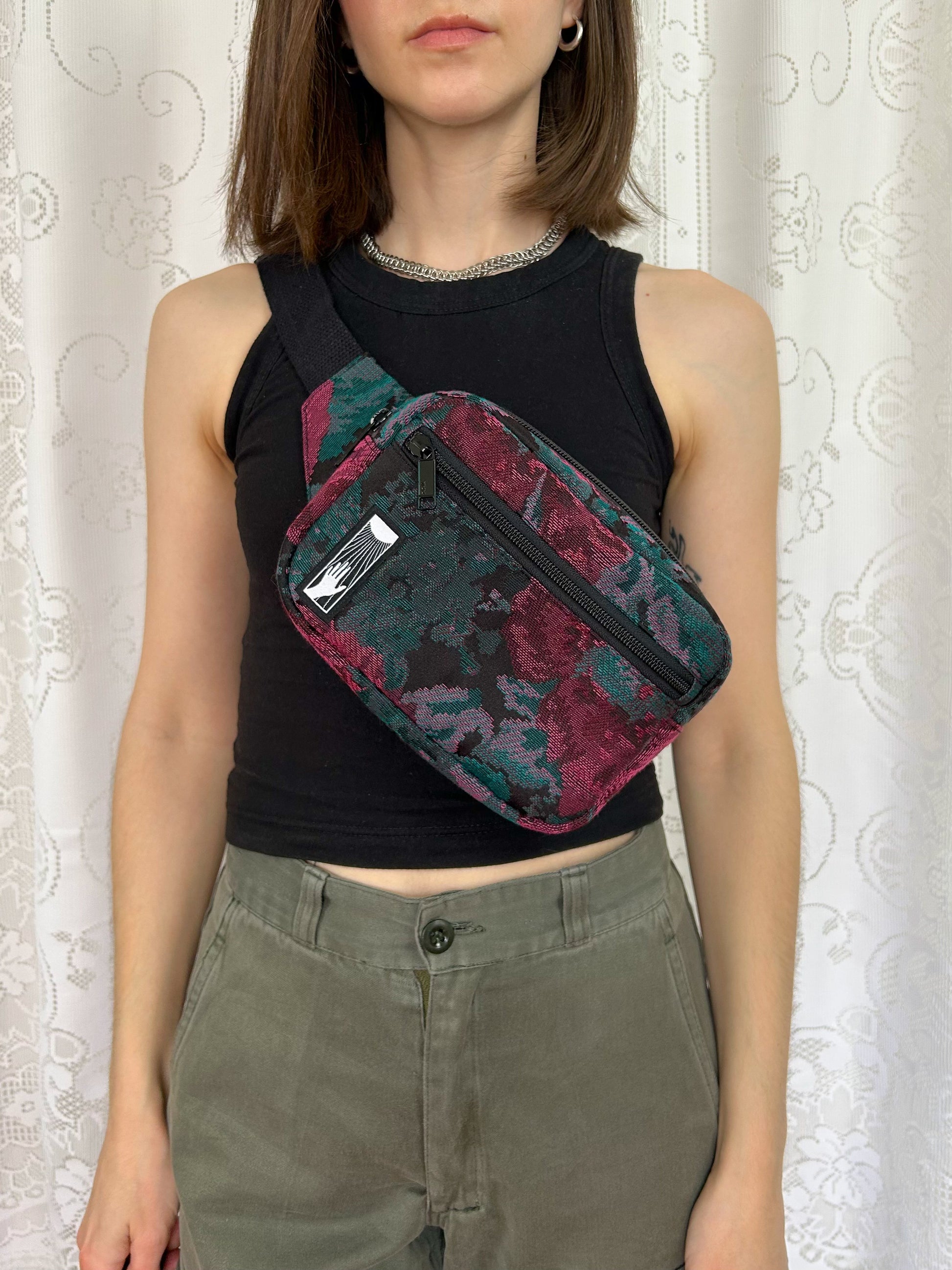 Woman wearing the fanny pack cross-body in front of a white lace backdrop