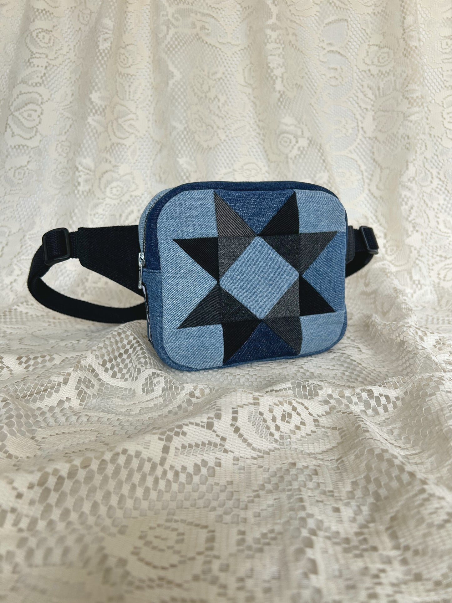 Front angled view of the same fanny pack with an ivory lace backdrop