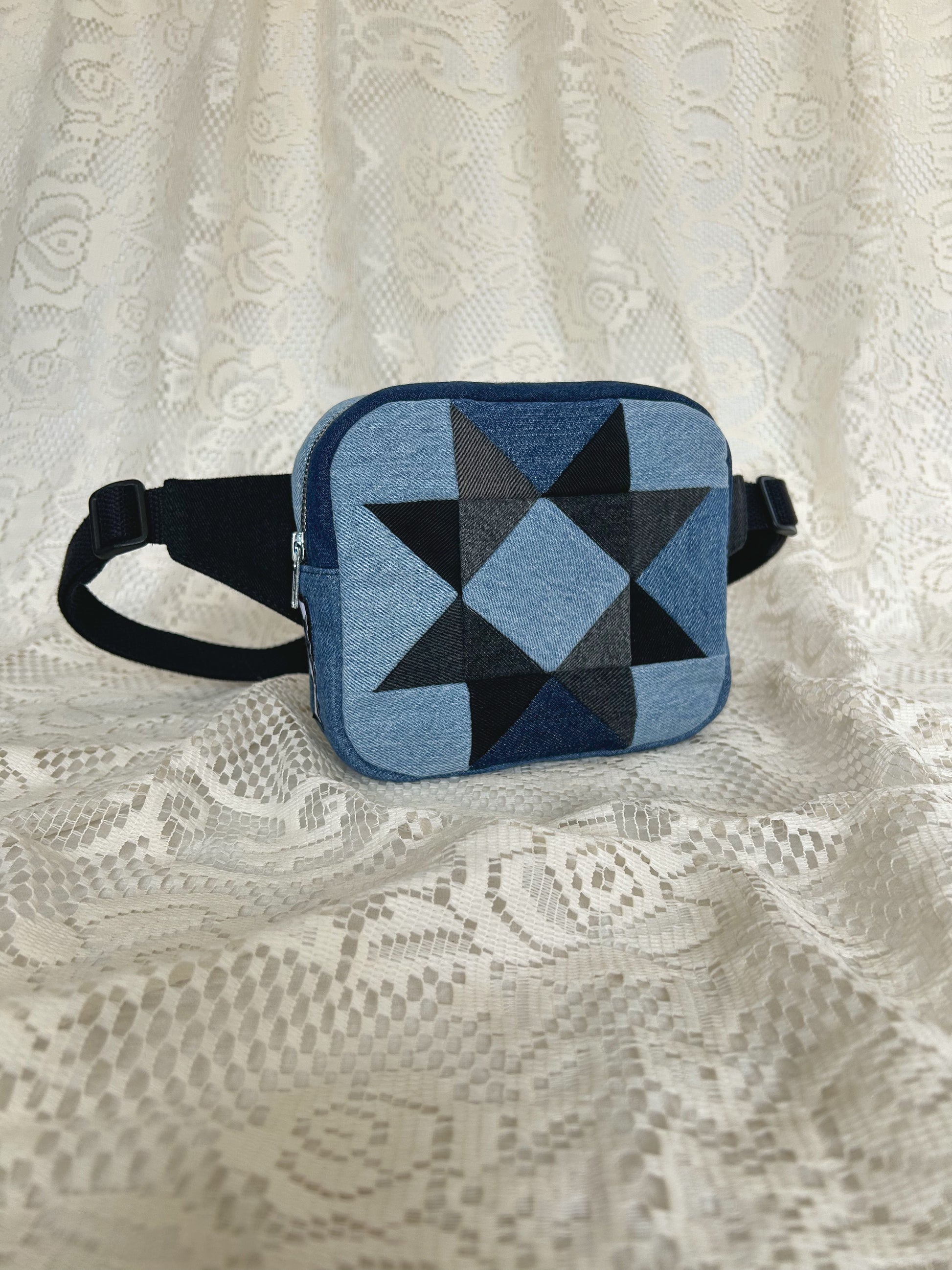 Front angled view of the same fanny pack with an ivory lace backdrop