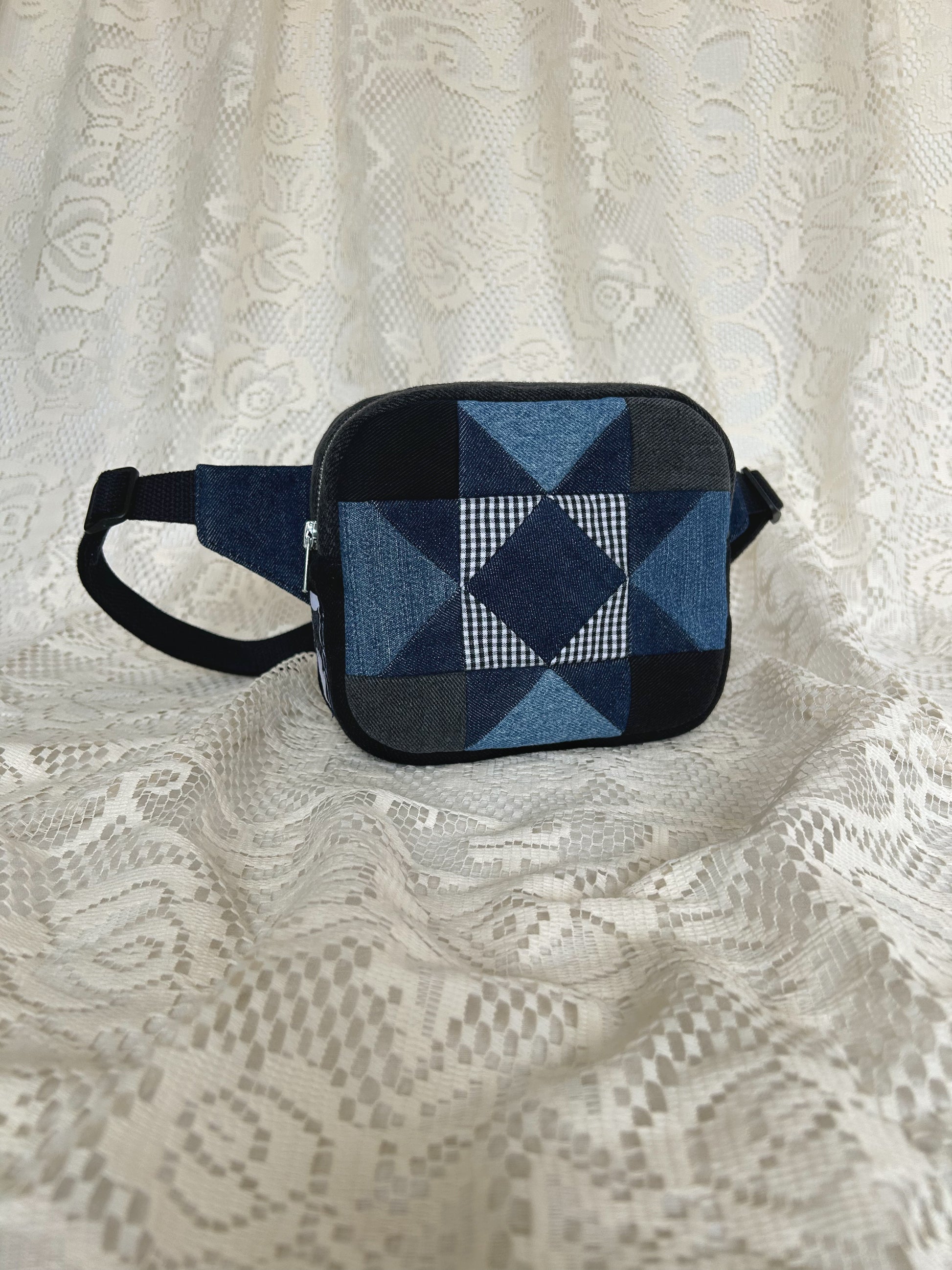 Front angled view of the same fanny pack with an ivory lace backdrop