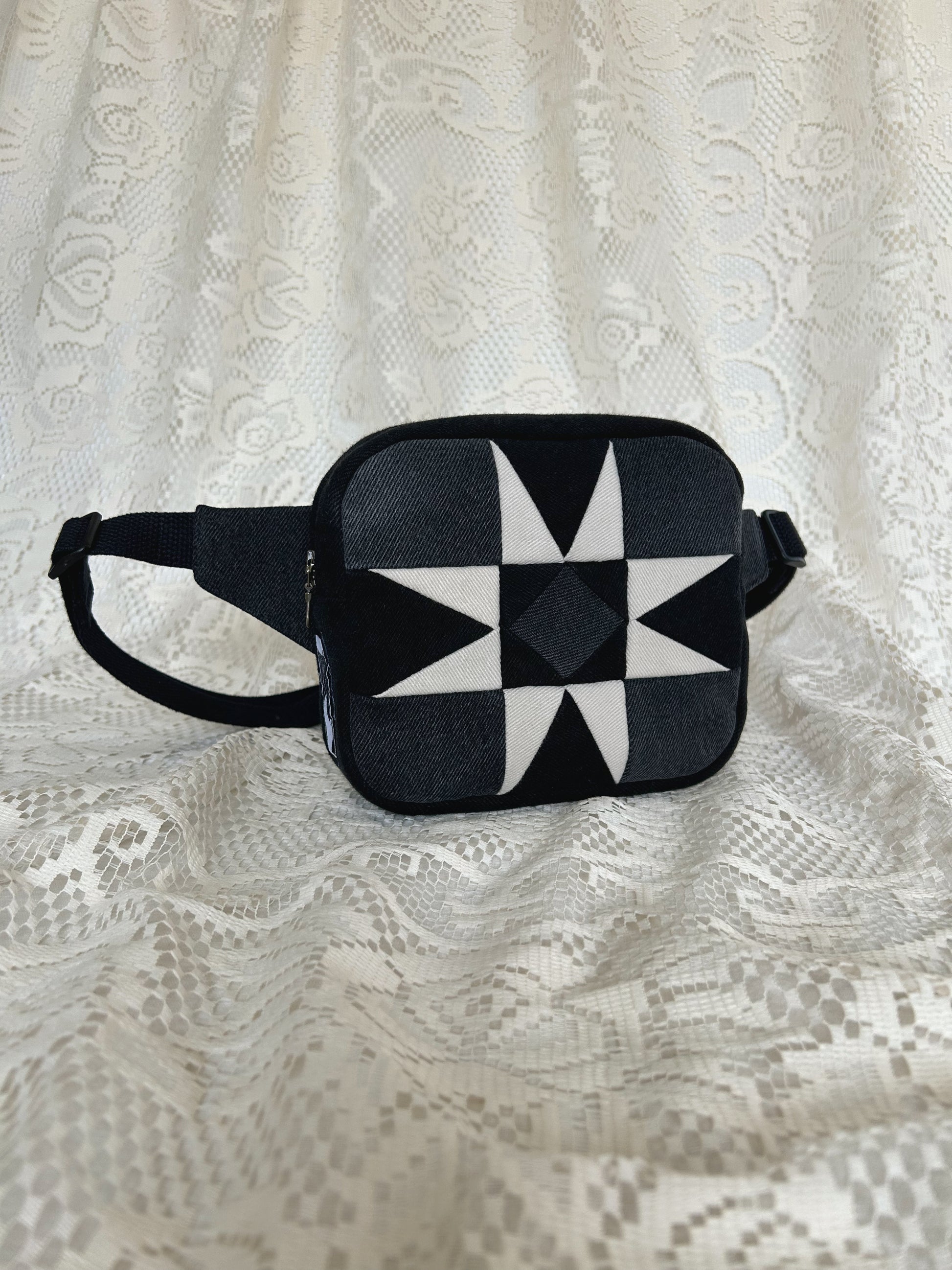 Front angled view of the same fanny pack with an ivory lace backdrop