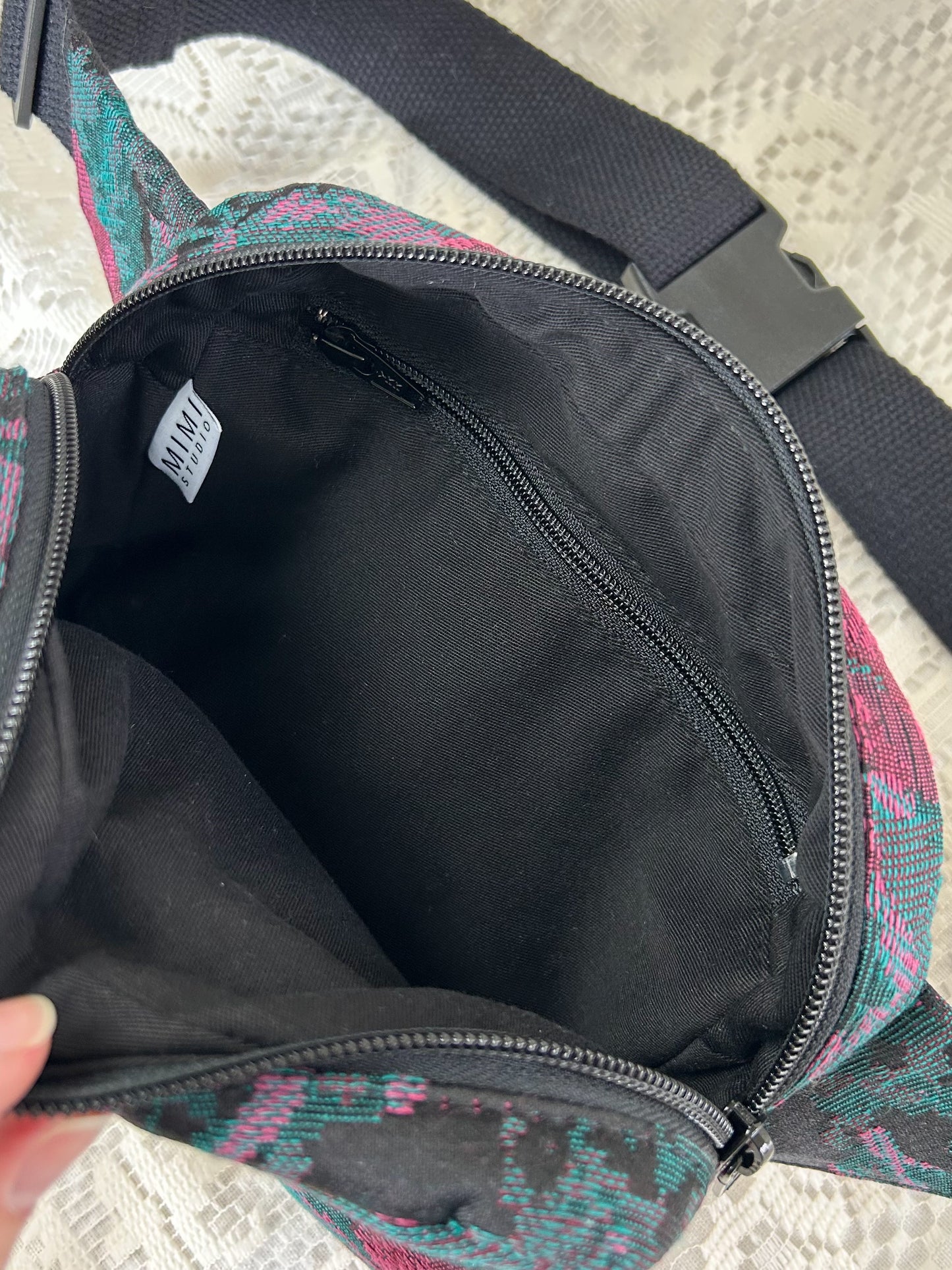 Interior lining of fanny pack made using black twill fabric with a zippered pocket