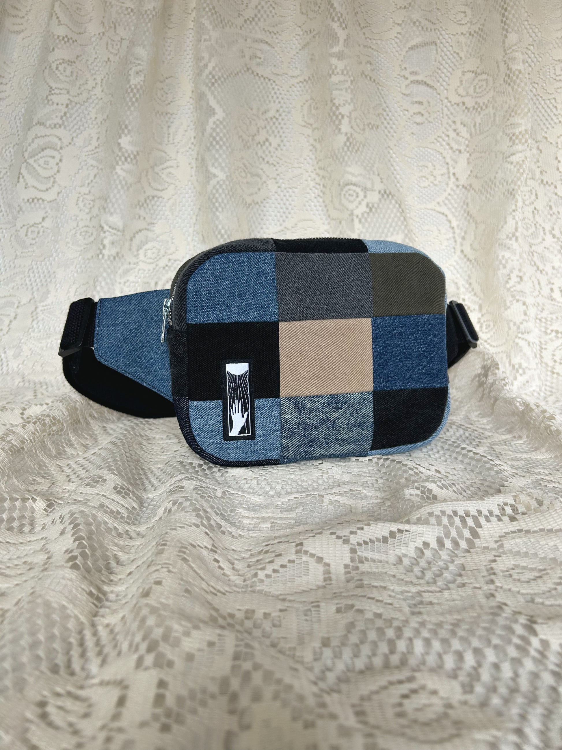 Angled front view of the fanny pack with an ivory lace backdrop