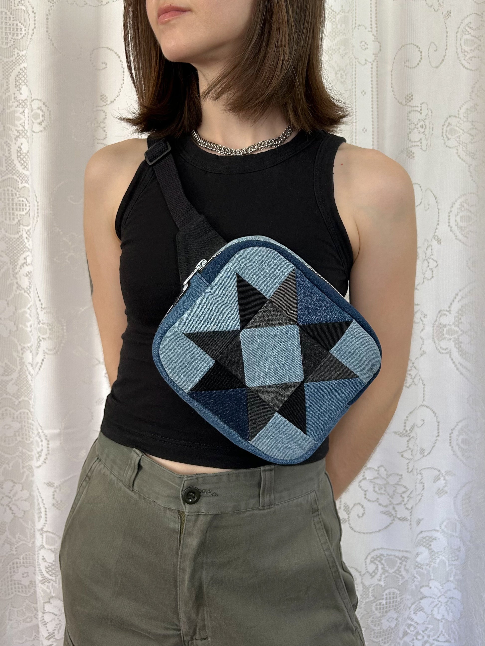 Woman wearing the same fanny pack cross-body in front of a white lace backdrop