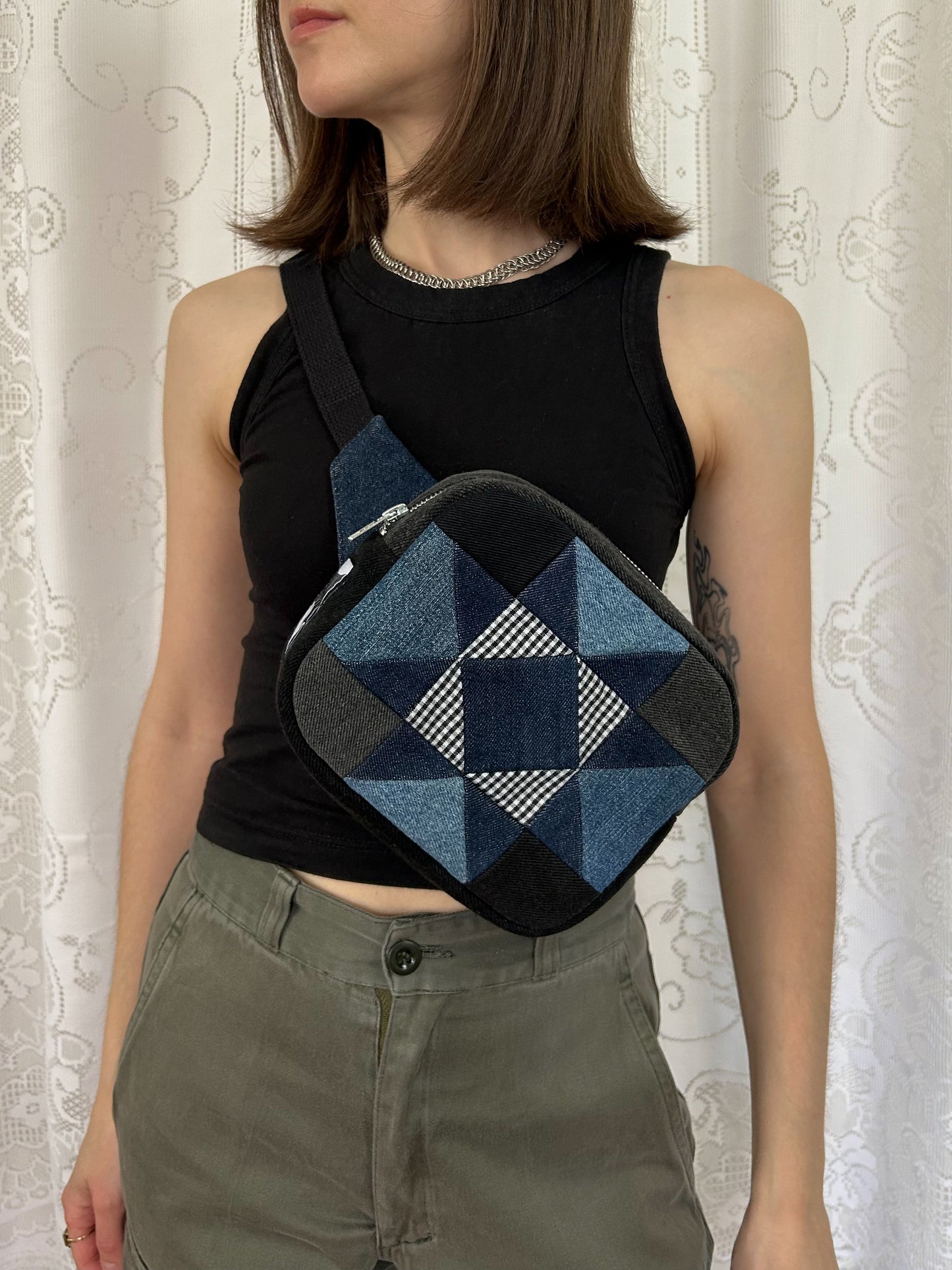 Woman wearing the same fanny pack cross body in front of a white lace backdrop