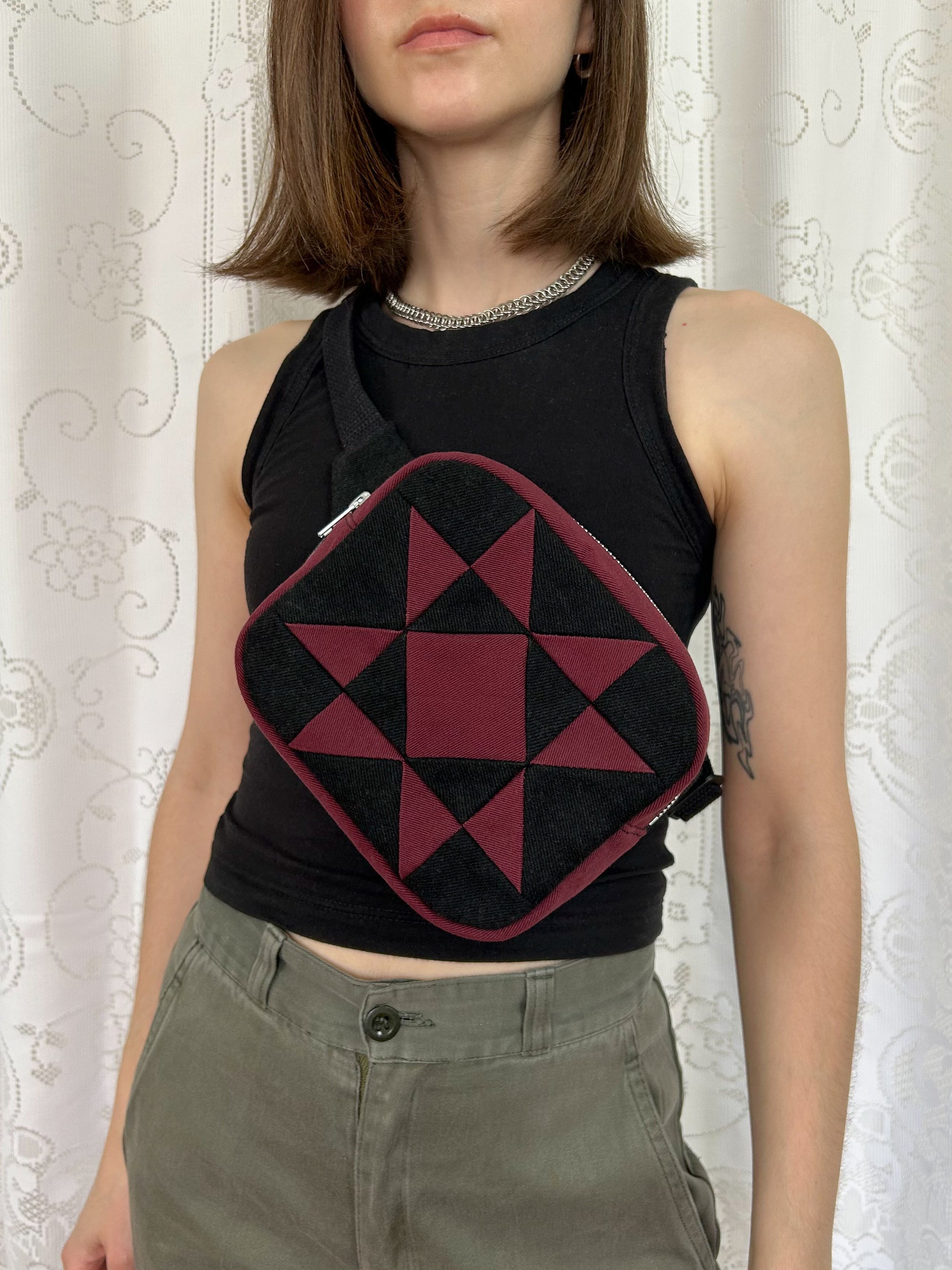 Woman wearing the same fanny pack cross body in front of a white lace backdrop