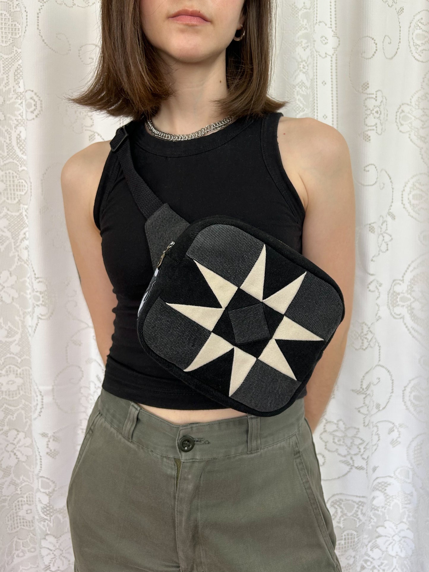Woman wearing the same fanny pack cross body in front of a white lace backdrop