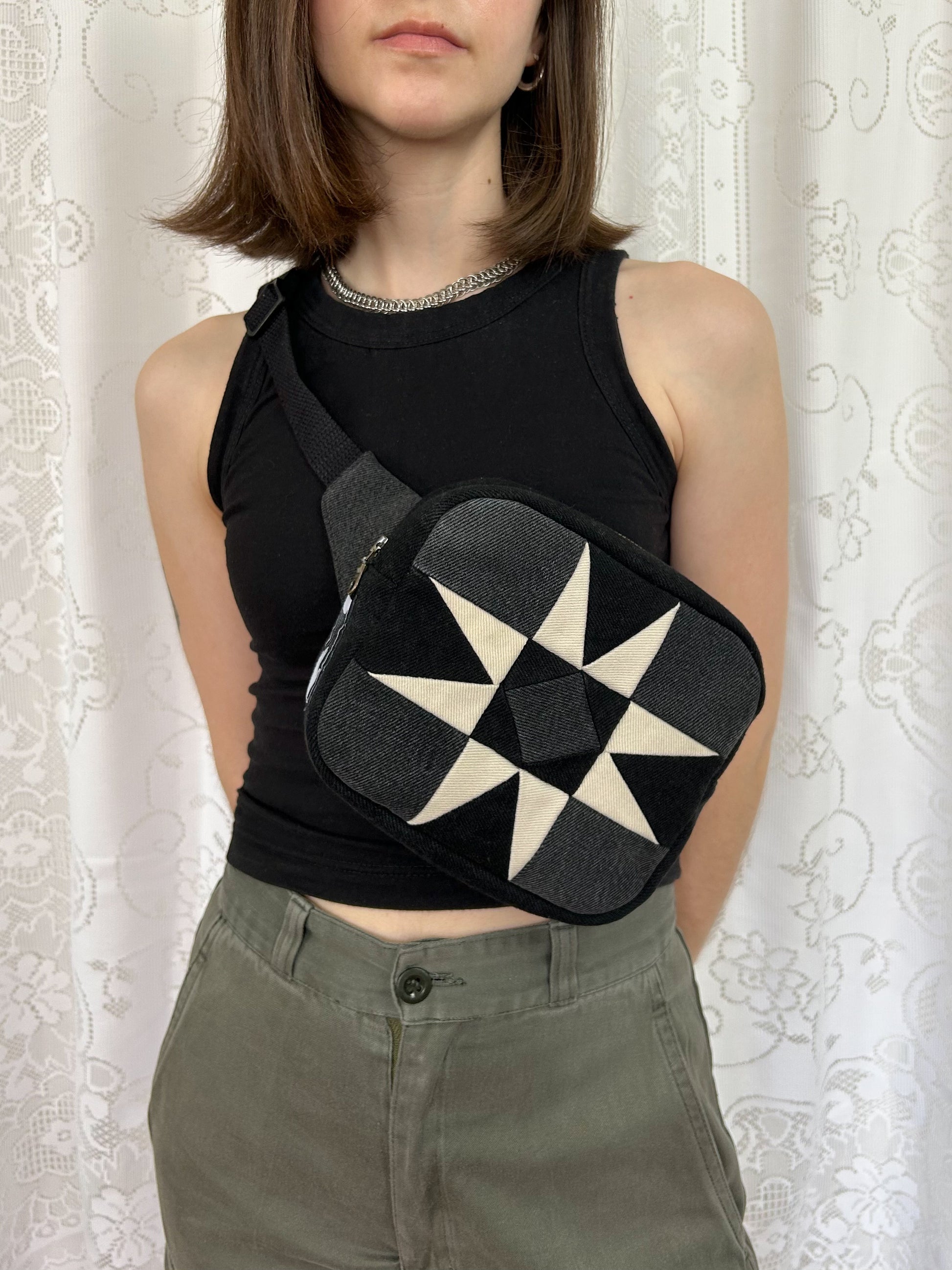 Woman wearing the same fanny pack cross body in front of a white lace backdrop