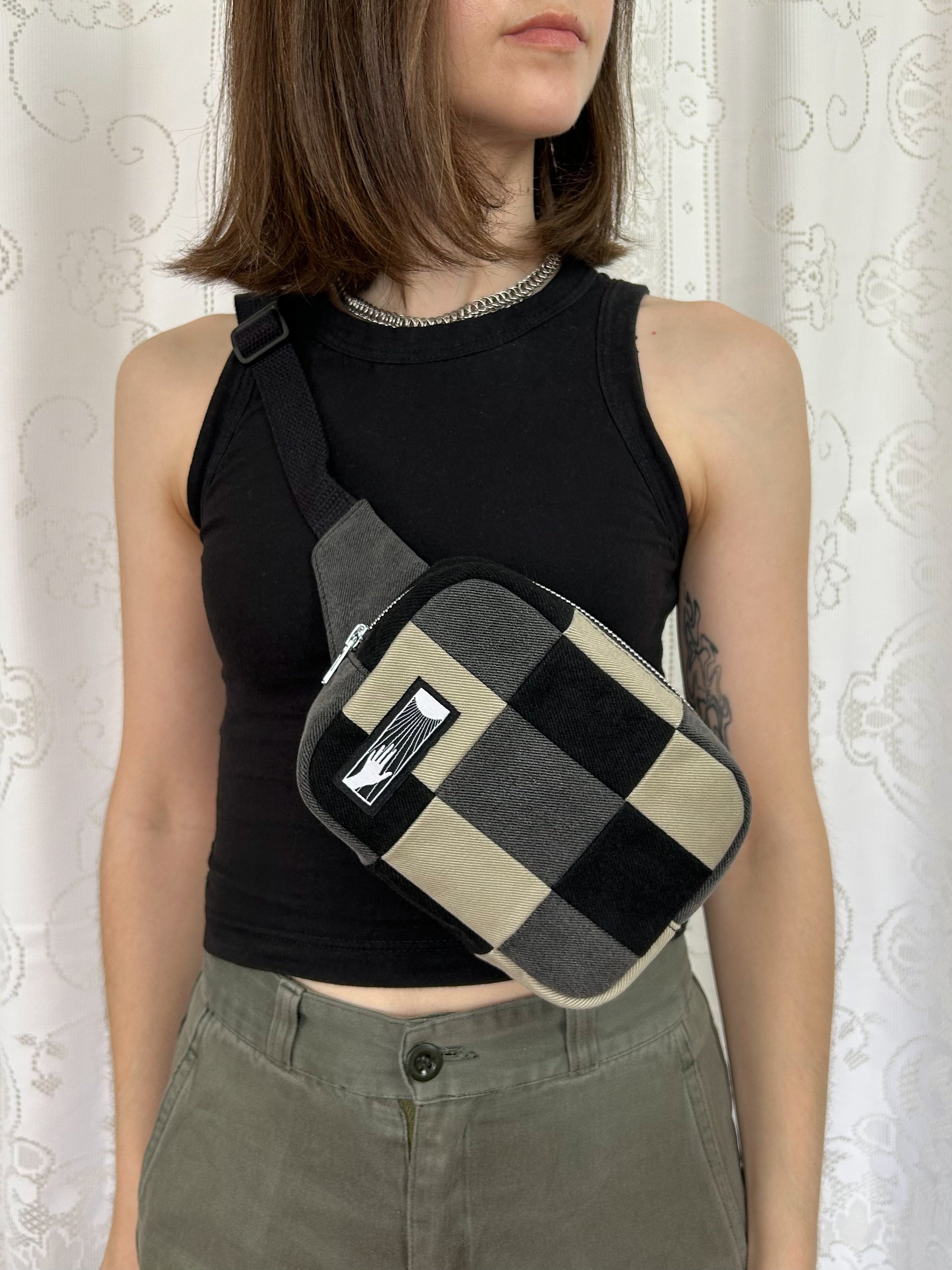 Woman wearing the fanny pack cross-body in front of a white lace backdrop