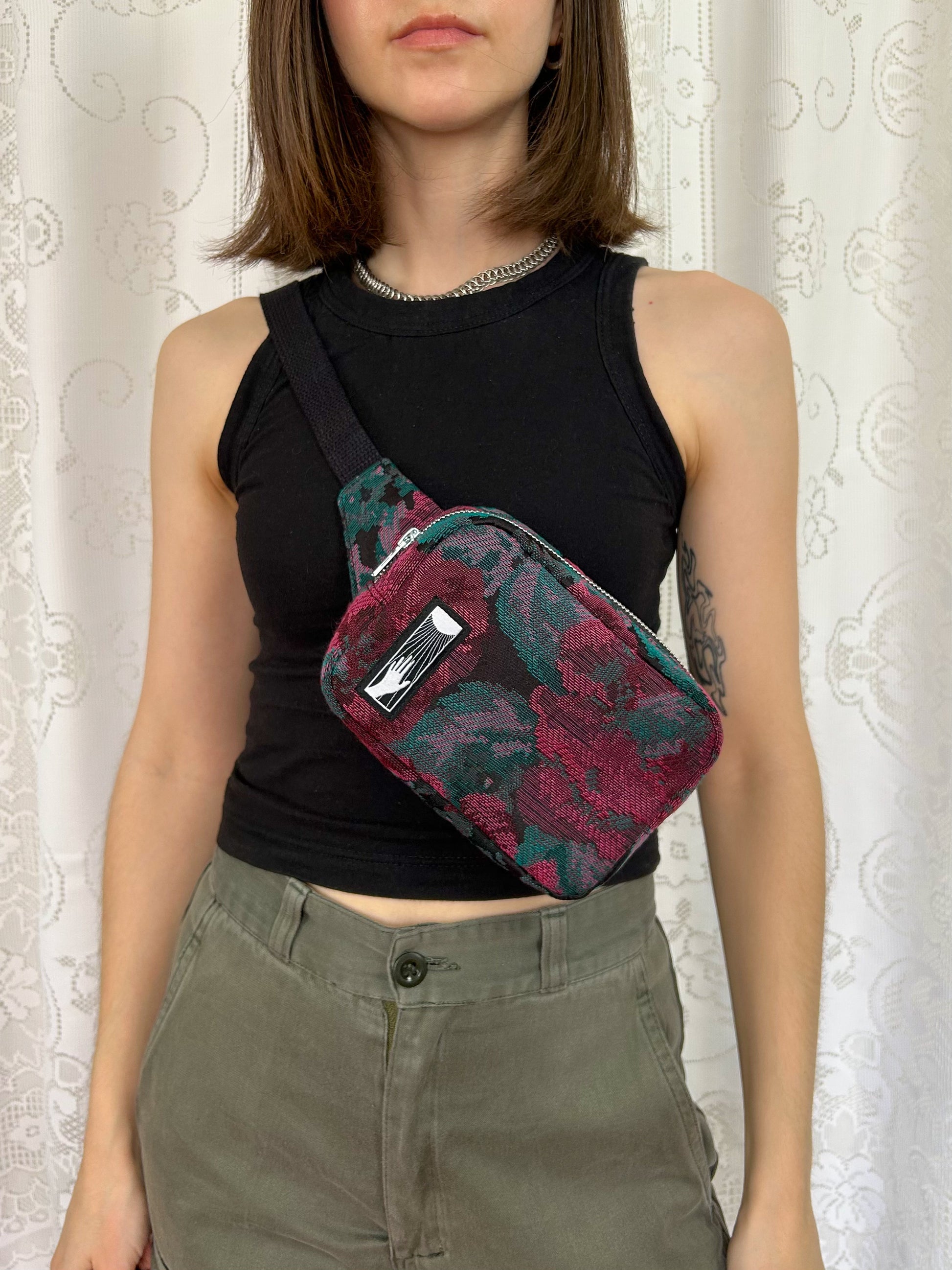 Woman wearing the same fanny pack cross-body in front of a white lace backdrop