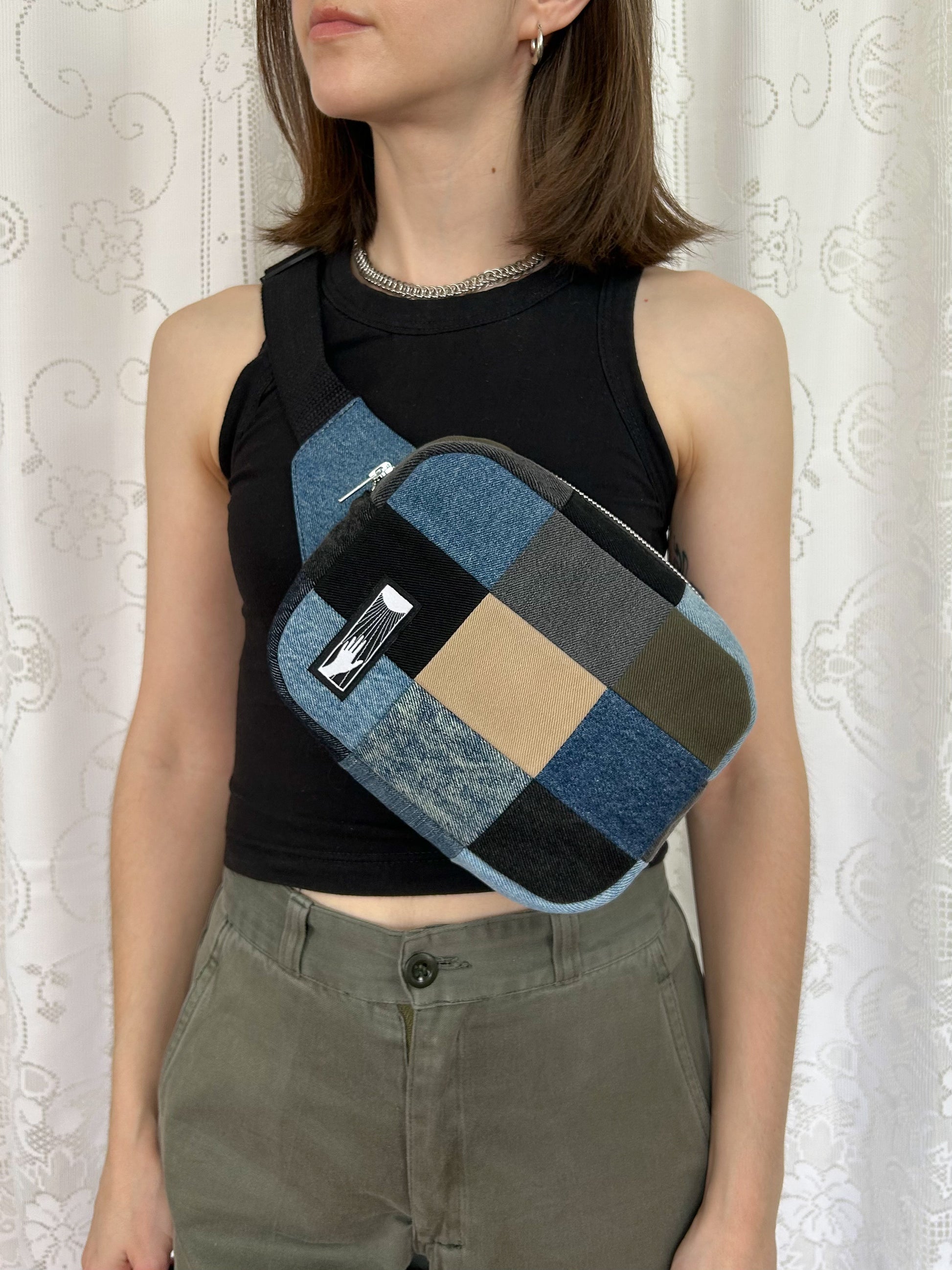 Woman wearing the fanny pack cross-body in front of a white lace backdrop